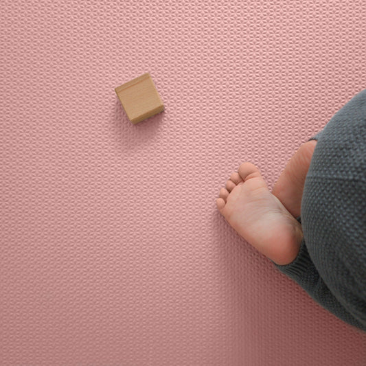 Baby playing on their knees on an EVA Foam Rug for Playroom