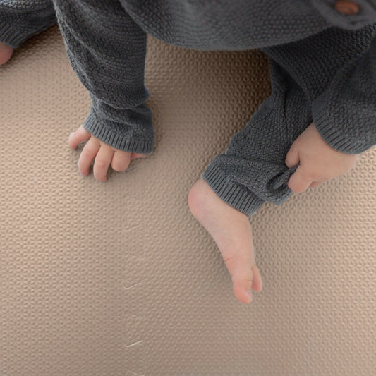 Toddler enjoying playtime on a baby puzzle foam floor mat in whipped mocha